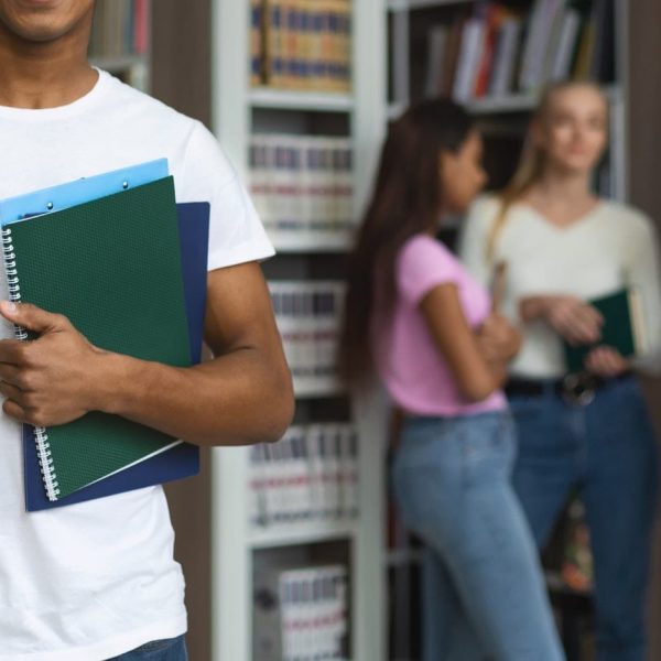 Black student standing in front of group of other students