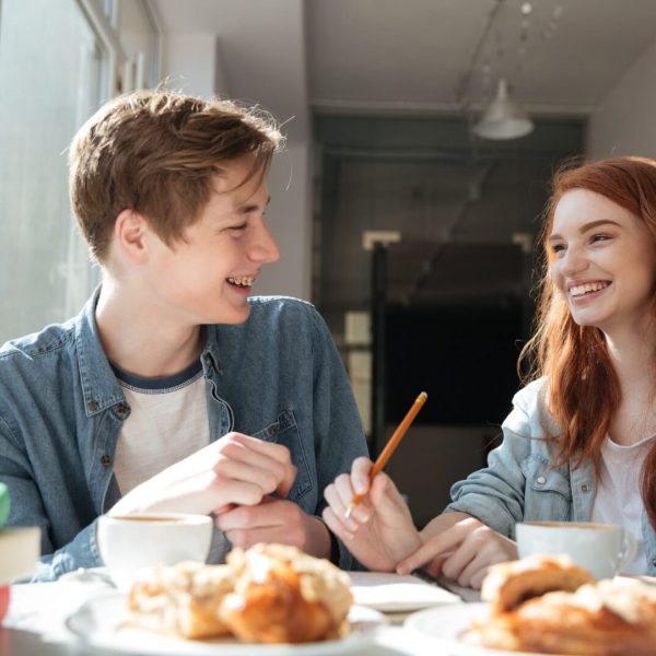 Shot of conversation of two students in cafe